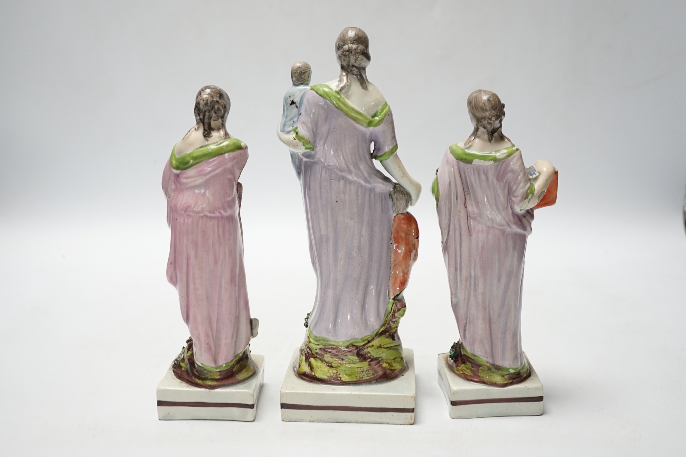 A set of three pearlware figures of Faith, Hope and Charity, c.1810, largest 21cm high